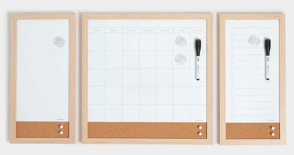 Three wood-framed white boards in a row: a monthly dry-erase calendar in the middle, a lined to-do board and a plain board, each with a cork strip.