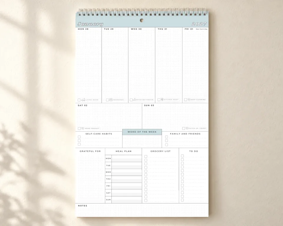 The Organized Mom Collective weekly family wall calendar with sections for plans, meals and groceries.