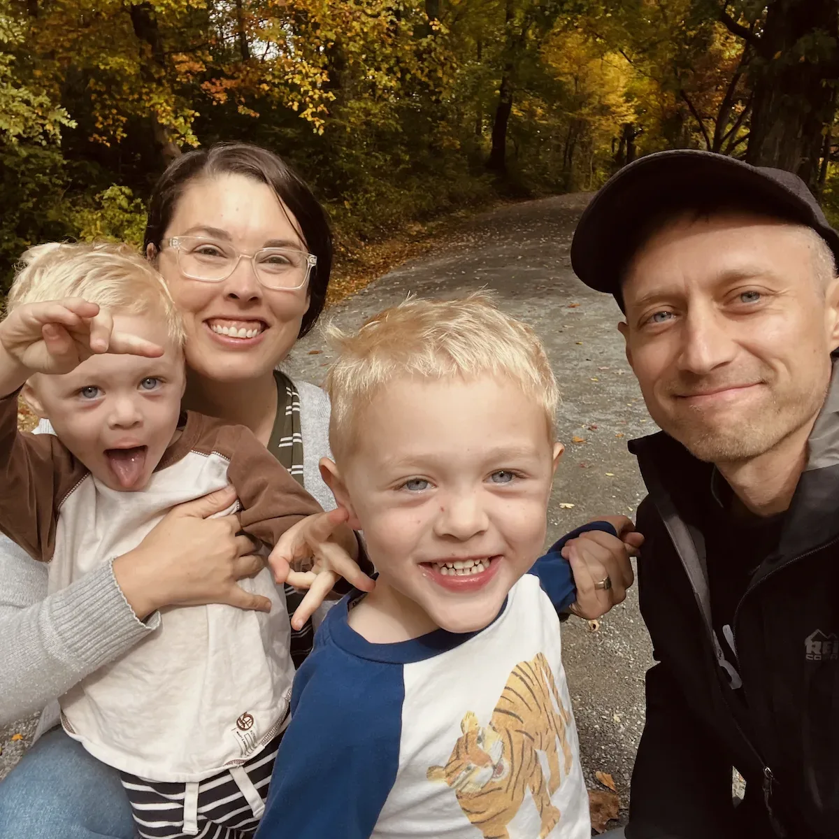 Mark and Megan with their two sons on a wooded path in autumn